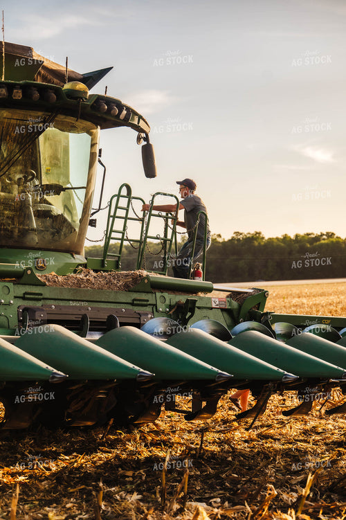 Farmer Climbing into Combine 115370