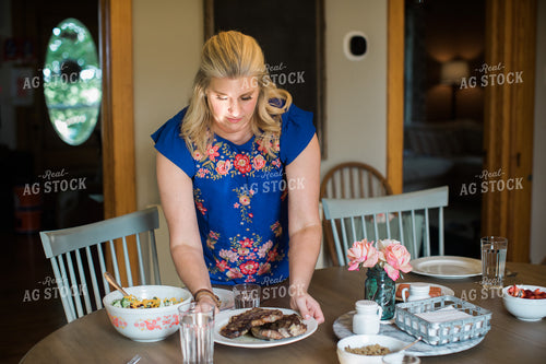 Farm Wife Putting Steak on Table 4426