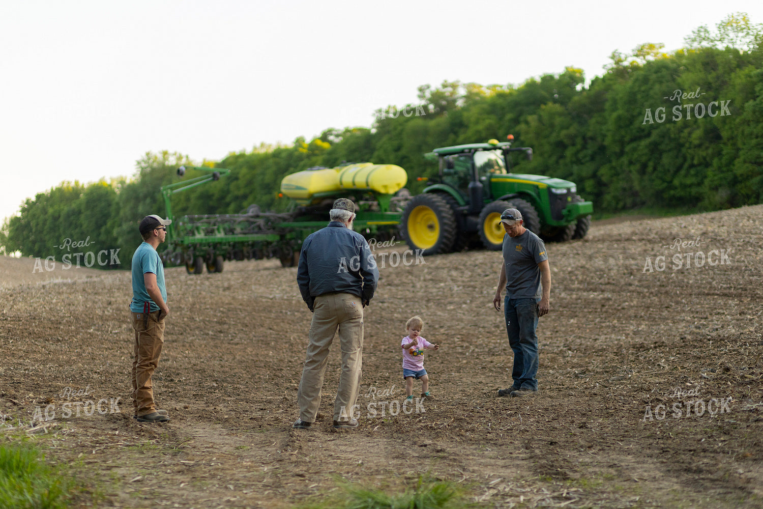 Farm Family Talks by Planter in Field 93257