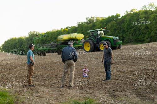 Farm Family Talks by Planter in Field 93257