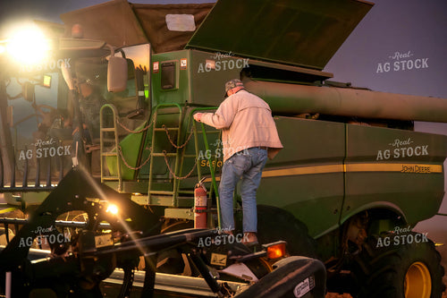 Farmer Climbing into Combine 115447