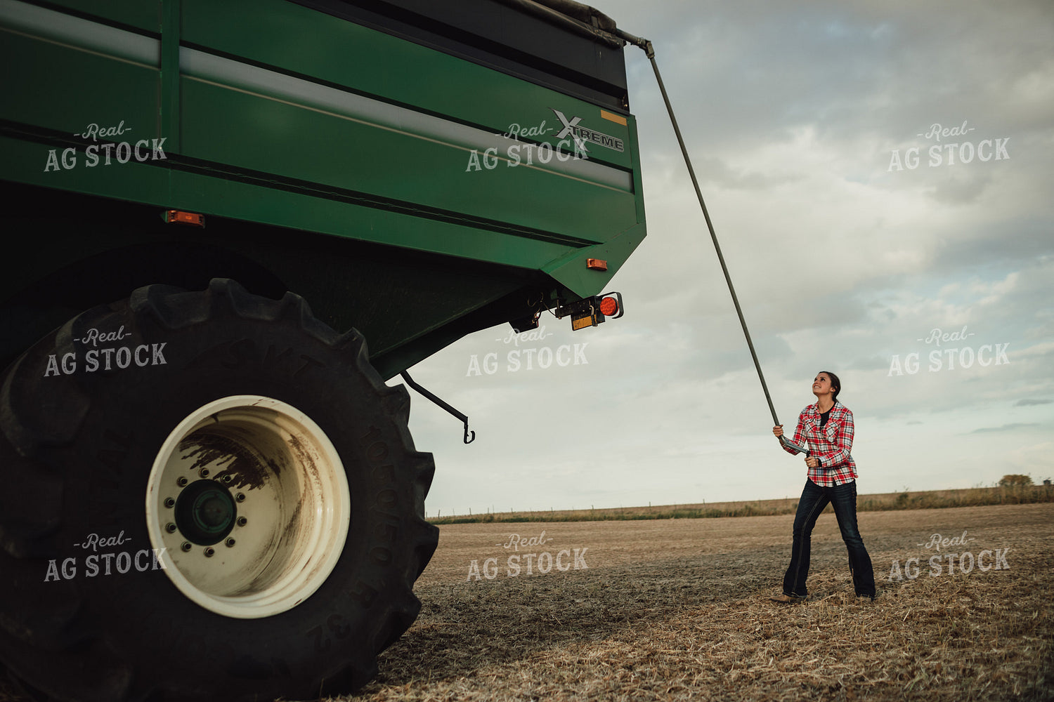 Female Farmer Tarping Grain Cart 3436