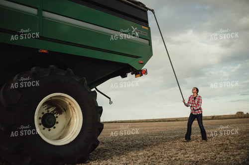 Female Farmer Tarping Grain Cart 3436