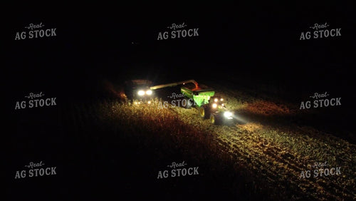 Aerial of Corn Harvest Combine Unloading at Dark 52584