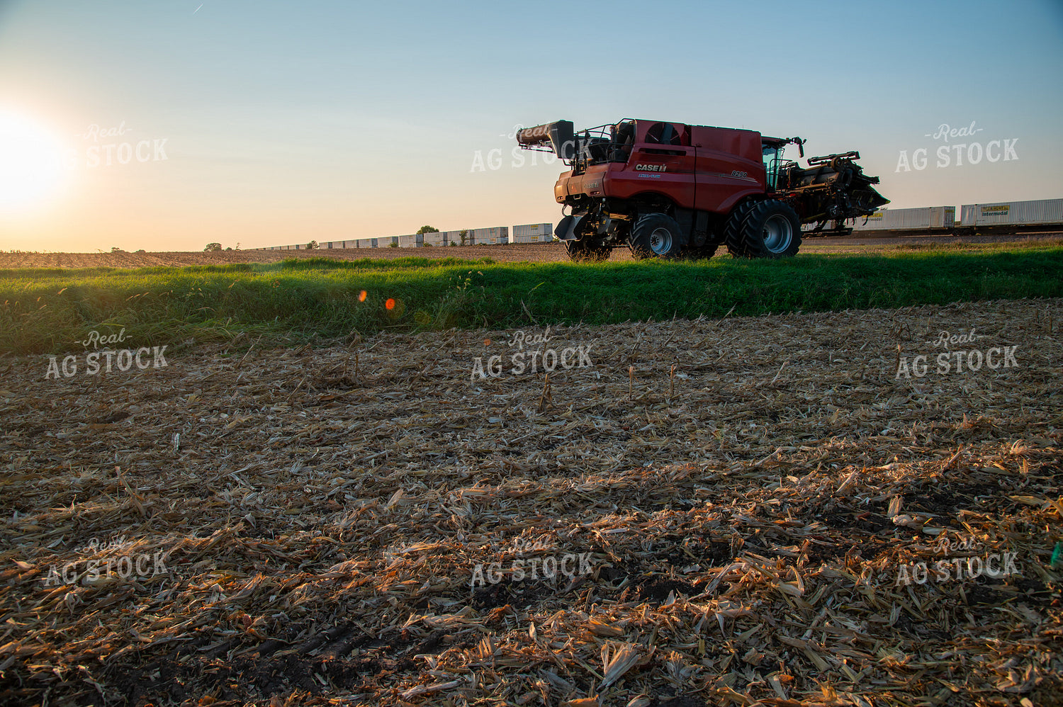 Combine Waiting for Train at Railroad Tracks 25447
