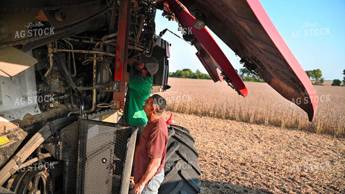 Multigenerational Farm Familiy Repairing Combine in a Bean Field 25533