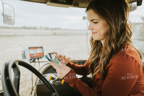 Female Farmer Using Phone in Tractor 8544