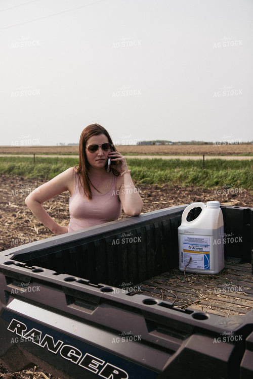 Female Farmer Talks on Phone Leaning on Ranger Tailgate 67287