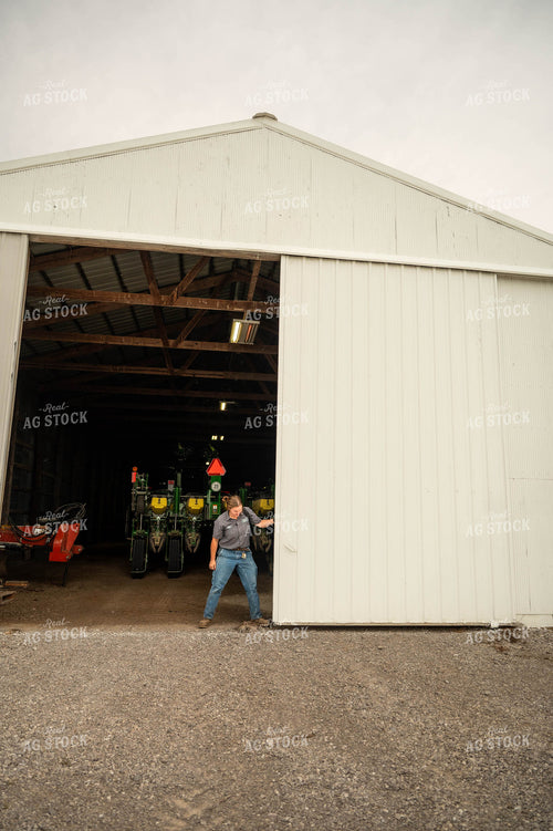 Female Farmer Opening Shed Doors 115718