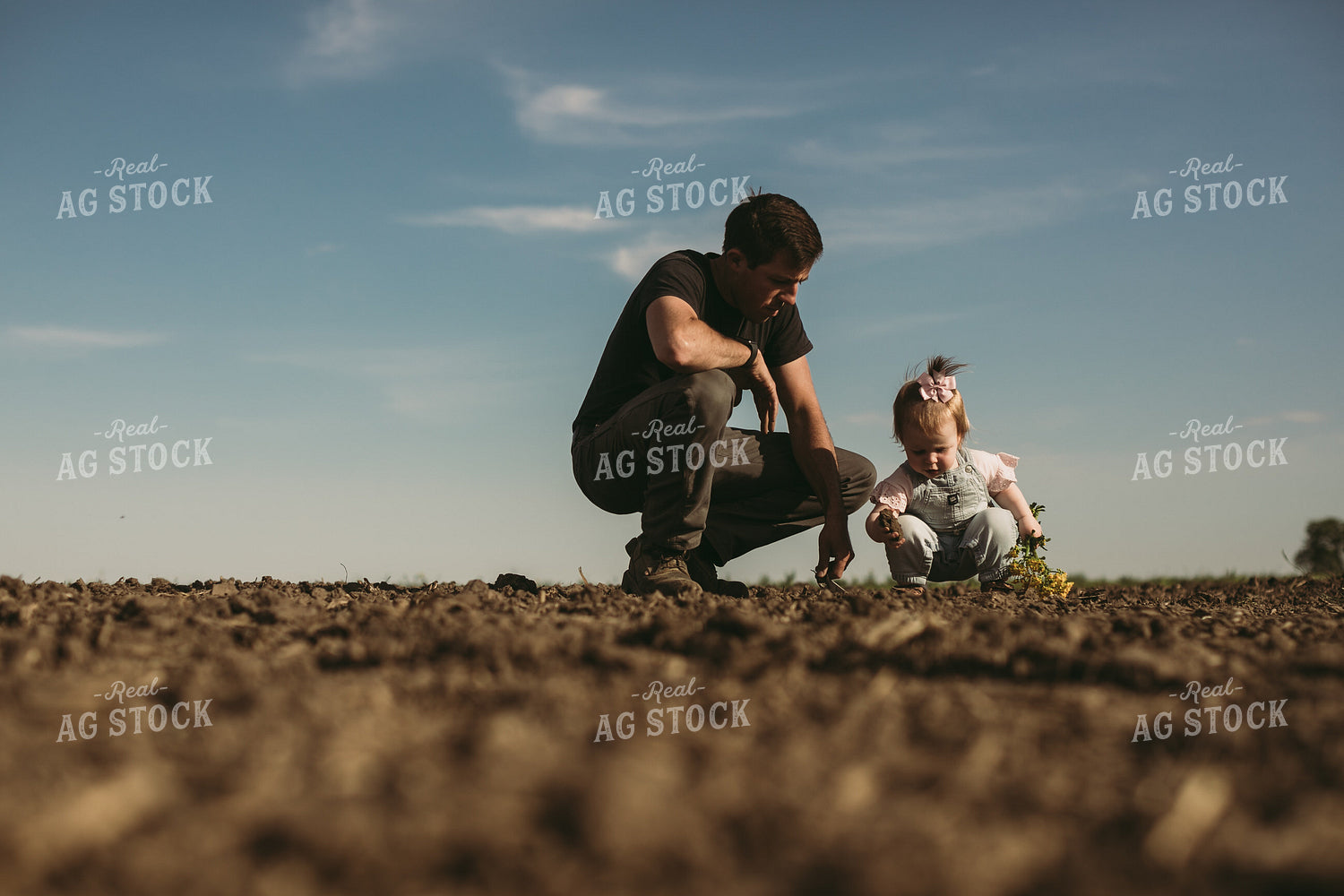 Farmer and Daughter Checking Seed Depth 4177