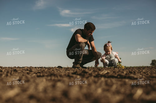 Farmer and Daughter Checking Seed Depth 4177