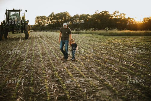 Farmer and Son Walking Through Field 6897