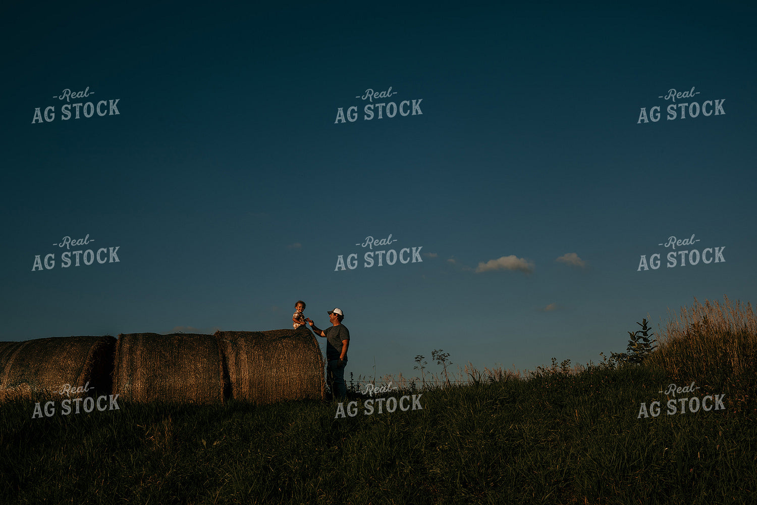 Farmer with Child Hay Bales 3169