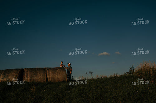 Farmer with Child Hay Bales 3169