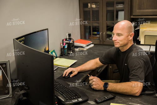 Farmer Works on Computer in Office 7493