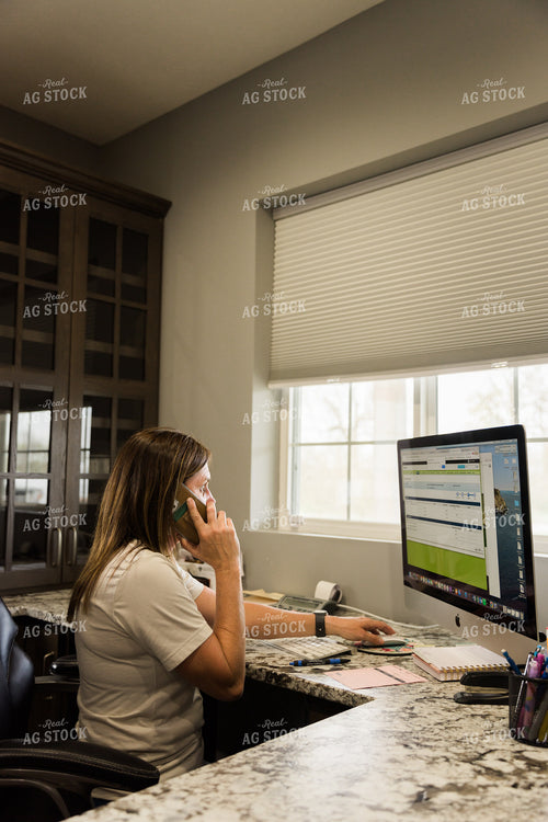 Woman Farmer Works on Computer While Talking on the Phone in Office 7510