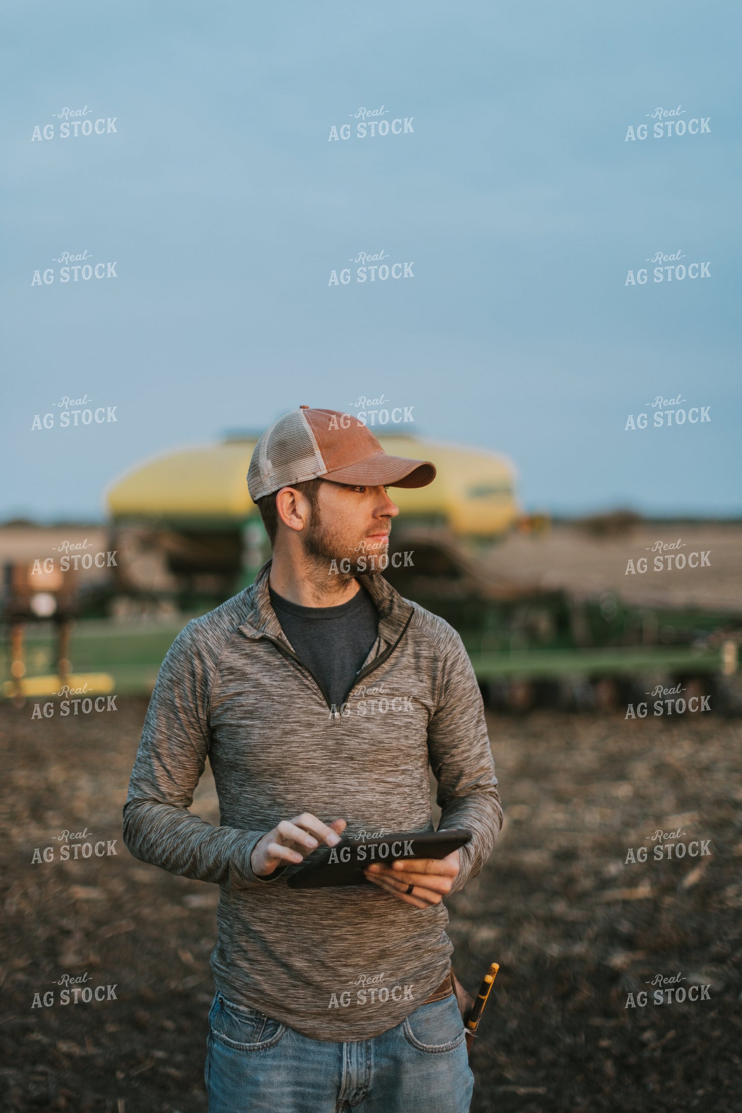 Farmer using Tablet in Field by Planter 8253