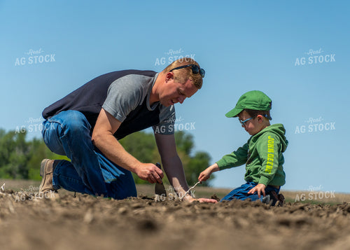 Farmer and Son Checking Seeds 65236