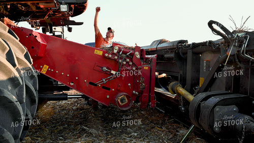 Farmer Directing Combine onto New Head 25521