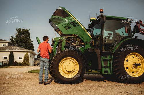 Farmer Checking Tractor Oil 4455