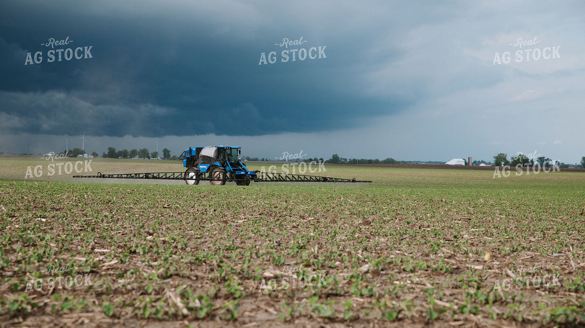 Self-Propelled Sprayer Working Early-Season Crop Field Under Dramatic Storm Sky 401046