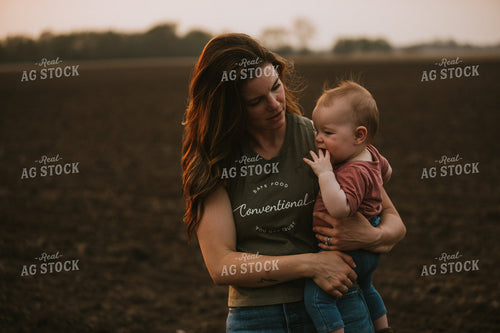 Farm Mom with Farm Kid in Field During Planting 5724