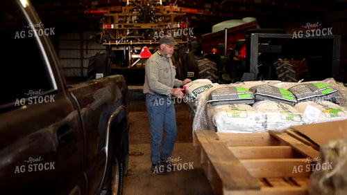 Farmer Loading Seed Bag into Truck 4071