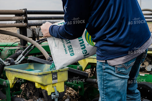 Farmers Pours Seed into Planter 133007