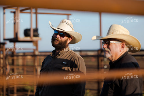 Ranchers Talking by Fence 205075