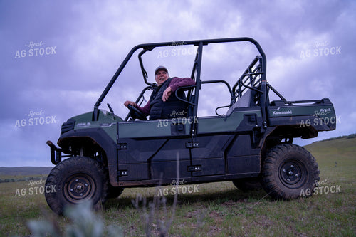 Man Posing in UTV Under a Dramatic Sky 65344