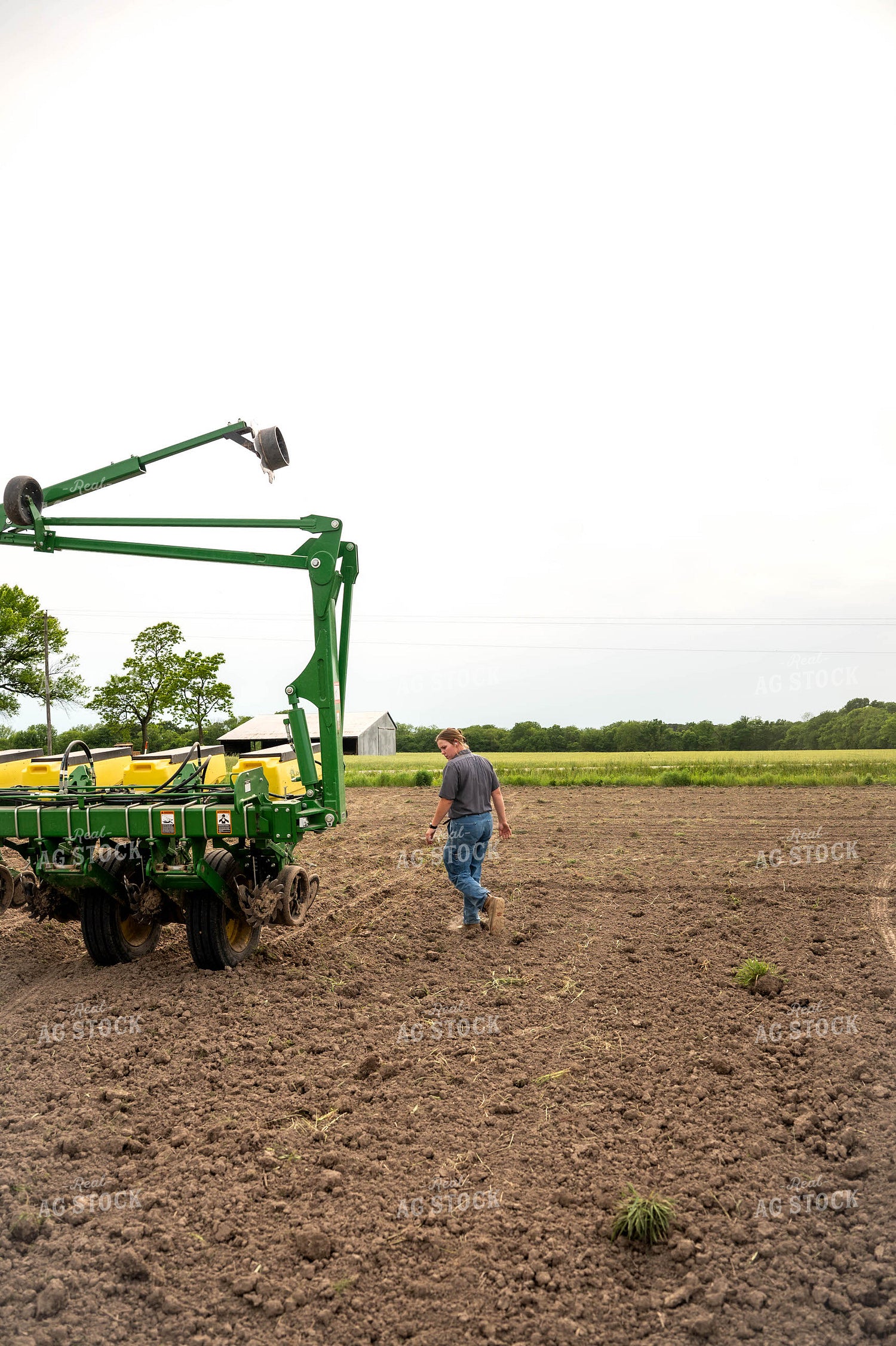 Female Farmer Walking by Planter 115653