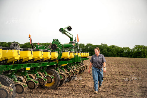 Female Farmer Walking by Planter 115659