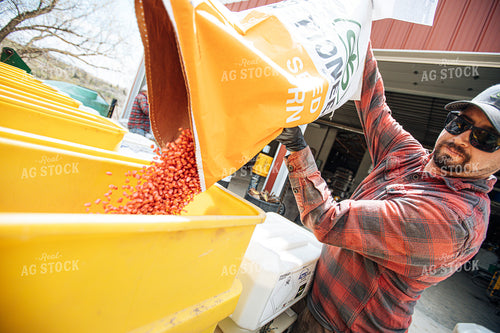 Farmer Filling Planter with Seed Bag 250160