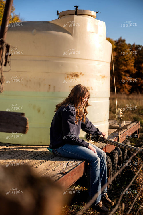 Female Farmer Filling Water Trough 115479