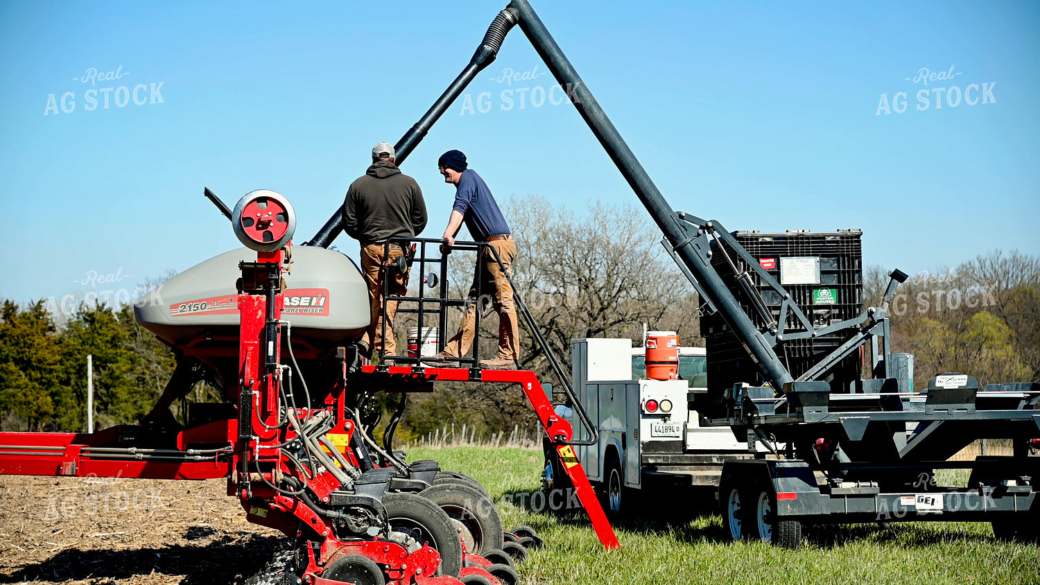 Farmer Loading the Planter with the Seed Tender 25095