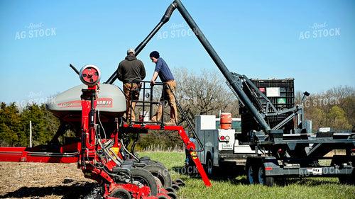 Farmer Loading the Planter with the Seed Tender 25095