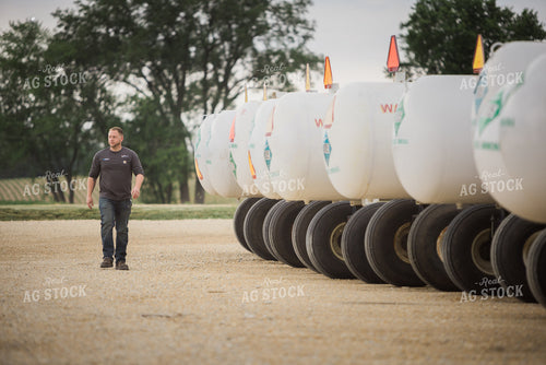 Retailer Walking by Anhydrous Tanks 7897