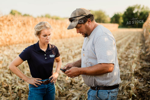 Farmer and Agronomist Using Phone in Field 8292