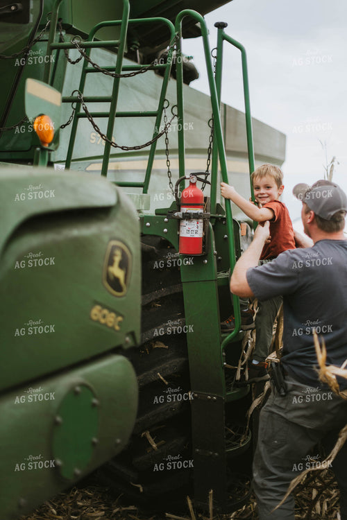 Farmer and Son Cimbing into Combine 8594