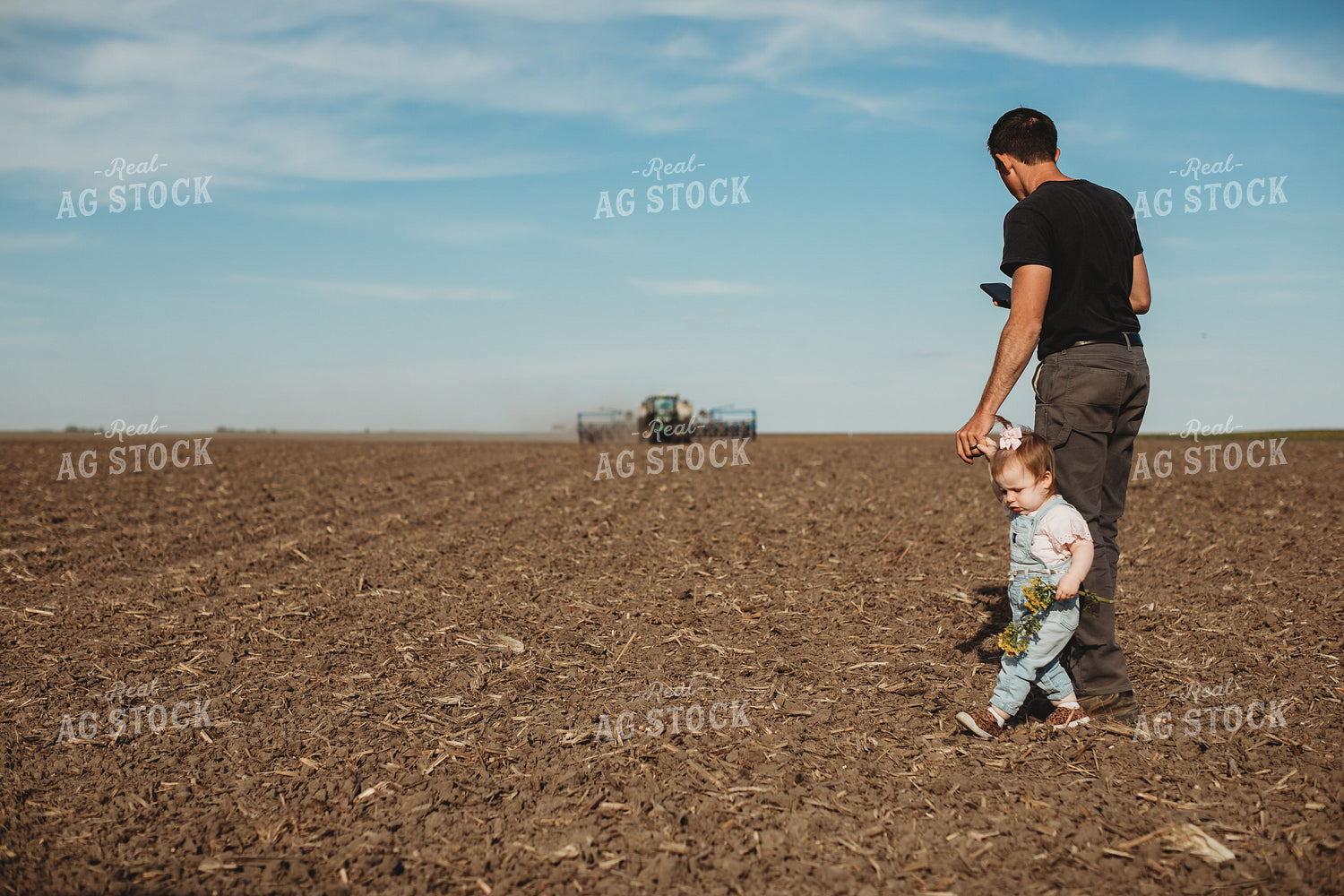 Farmer and Daughter with Tractor and Planter in Background 4184
