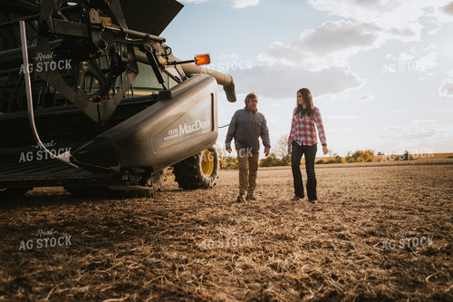 Farmer and Female Farmer Talking Outside of Combine 3522