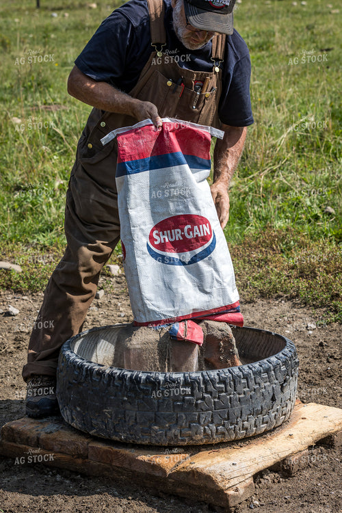 Farmer Pouring Feed 138084