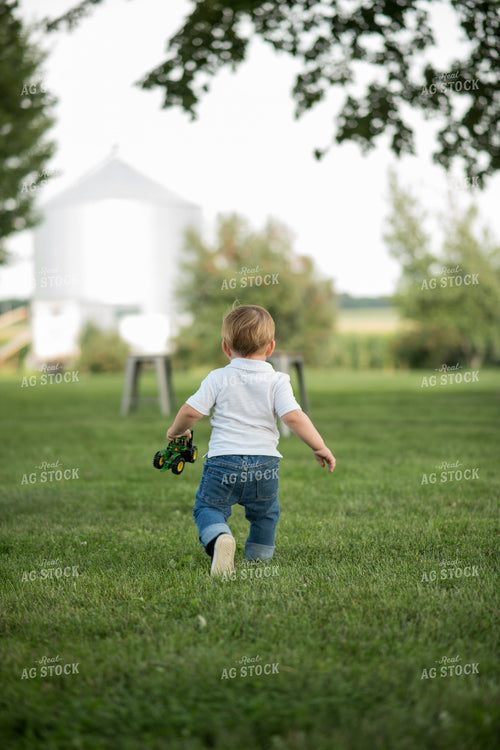 Farm Kid with Toy Tractor 76399