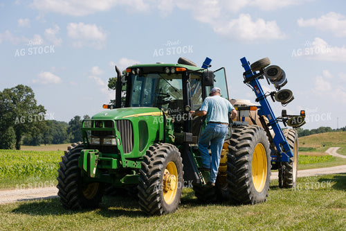 Farmer Climbing into Tractor 52961