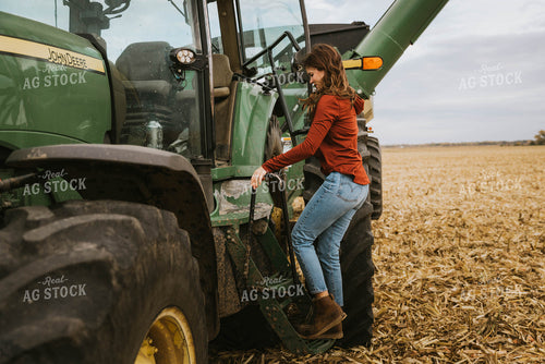 Female Farmer Cimbing into Tractor 8552