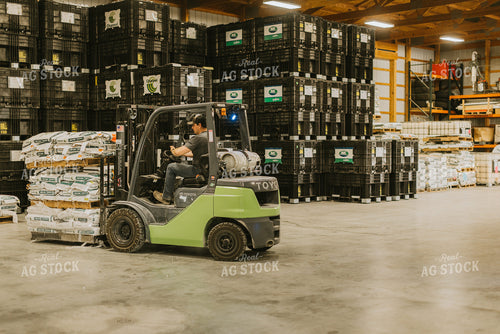 Farmer Loads Pallet with Skid Steer 7628
