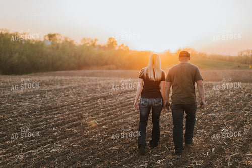 Young Couple Walk in Field at Sunset 7722