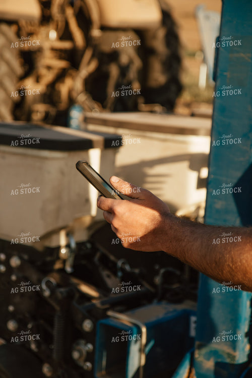 Farmer Using Phone by Planter 67562