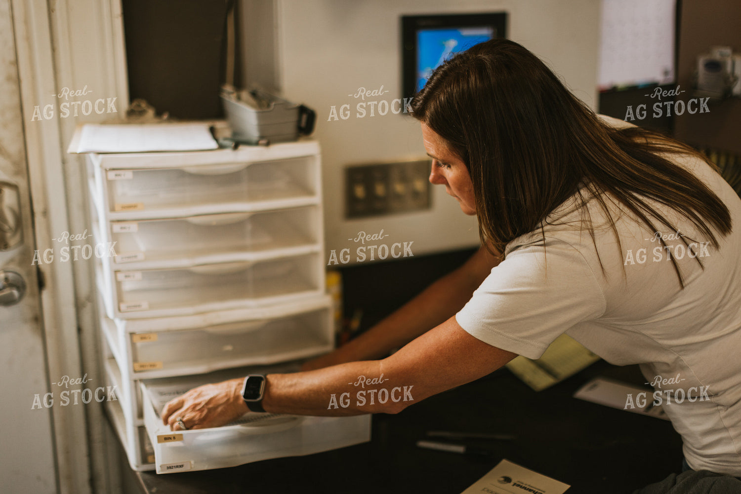 Woman Farmer Organizes Paper While Treating Seed 7566