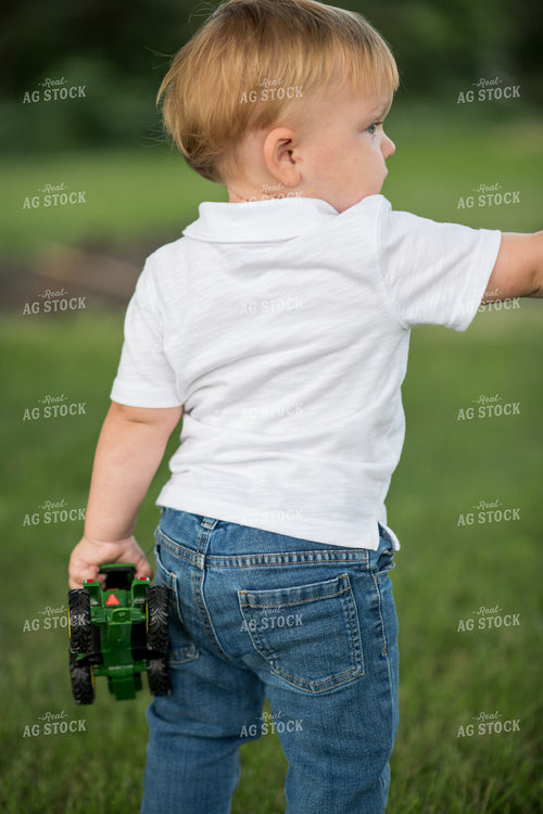 Farm Kid with Toy Tractor 76398